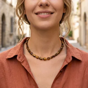 Natural irregular tiger eye stone beaded choker necklace worn by a female model in sunlight