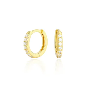 Detail shot of gold-plated S925 sterling silver hoop earrings with clear cubic zirconia.