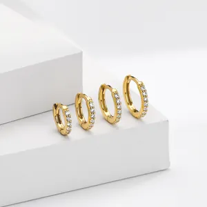 Detail view of four graduated S925 gold-plated silver hoop earrings with zircon stones