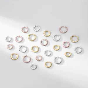 Heart-shaped arrangement of S925 sterling silver CZ hoop earrings in three colors.