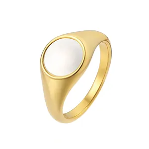 Minimalist gold signet ring featuring a polished round white shell inlay