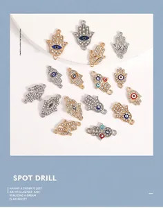 Detailed view of Hamsa hand charms with sparkling rhinestones and colorful evil eye enamel