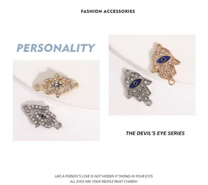 Macro detail of crystal-encrusted Hamsa hand and blue enamel evil eye alloy jewelry charms