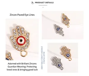 Detailed view of Hamsa hand charms with clear zircons and blue enamel eye accents.