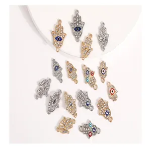 Detailed view of assorted Hamsa hand alloy charms with colorful enamel eyes and rhinestones