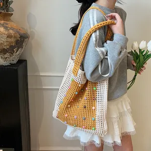 Close-up detail of a stylish hand-knitted hollow-out tote bag with colorful bead decorations