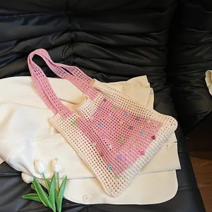 Detail view of pink and cream crochet knit tote bag with colorful bead accents