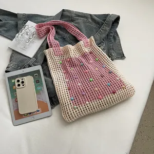 Detailed macro view of the hollow-out knit crochet tote bag decorated with colorful beads