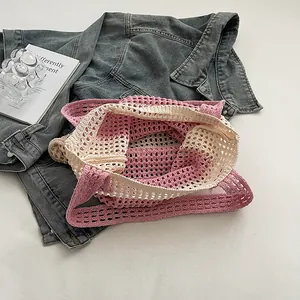 Detailed close-up of pink and beige crochet knit mesh tote bag showing delicate texture