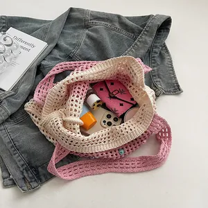 Close-up of pink crochet tote bag showing interior space with accessories