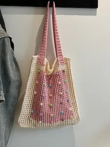 Stylish pink and cream crochet mesh tote bag decorated with colorful bead accents