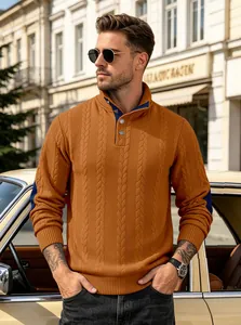 Macro view of men's orange cable-knit Henley sweater with navy contrast details