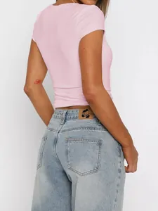 Rear view of a stylish pink slim-fit short sleeve T-shirt paired with blue jeans