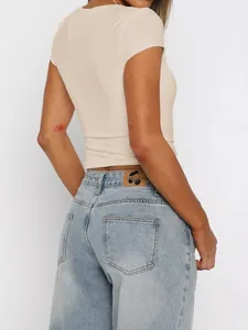 Back view of a slim fit beige short sleeve Y2K style t-shirt for women