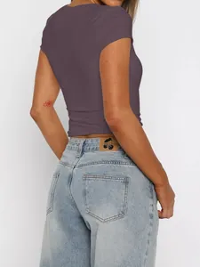 Detailed back view of a slim fit purple T-shirt with light wash denim jeans for women