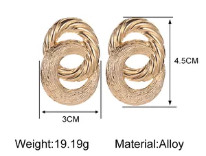 Detailed view of golden interlaced oval earrings with 4.5cm length and alloy texture