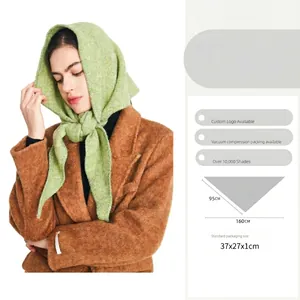Avocado green wool knit triangle shawl scarf accessory worn as a headscarf on model