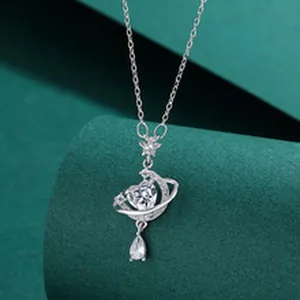 Detailed macro shot of silver heart necklace with crescent moon and star pendant