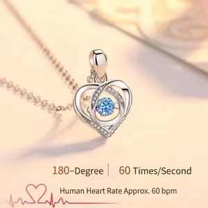 Close-up of a sterling silver heart pendant with a blue dancing stone detail