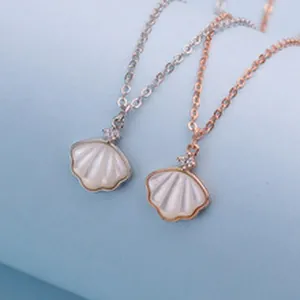 Close-up of minimalist S925 sterling silver shell necklaces in silver and rose gold