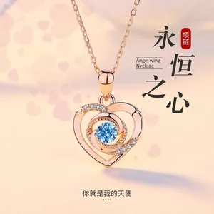 Elegant rose gold heart pendant necklace featuring a sparkling blue crystal center stone.