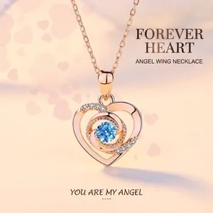 Elegant rose gold heart pendant necklace featuring a sparkling blue crystal center stone.