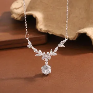 Detailed macro view of a 999 sterling silver necklace featuring leaf motifs and crystal