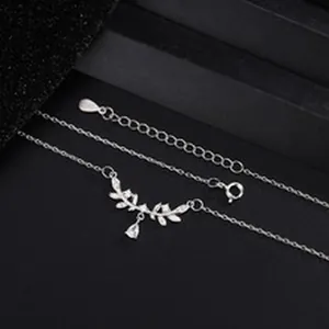 Detailed macro view of sterling silver leaf necklace decorated with marquise zircon