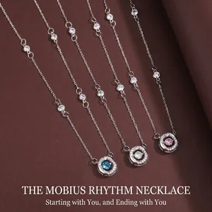 Detailed view of elegant silver Mobius necklaces with colored sparkling crystals