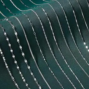 Variety of S925 sterling silver necklace chain styles displayed on a green velvet backdrop