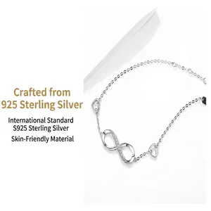 Detail of S925 sterling silver bracelet with infinity symbol and heart charms
