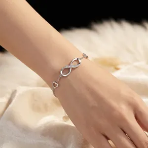Elegant S925 sterling silver infinity symbol and heart charm bracelet on a female wrist
