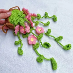 Detailed close-up of handmade crochet flower car hanging ornament with pink blossoms