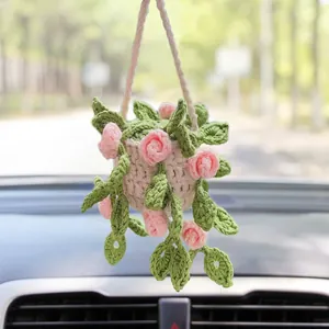 Detail view of handmade crochet pink rose hanging plant for car rearview mirror decor