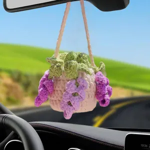 Close-up of a handmade crochet flower pot hanging ornament for car rearview mirror