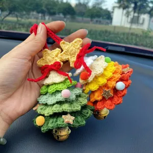 Detailed view of handmade crochet Christmas tree car hanging ornament with gold bell