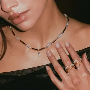 Detailed shot of an elegant gold-plated zircon ring set and necklace with water drop pendant
