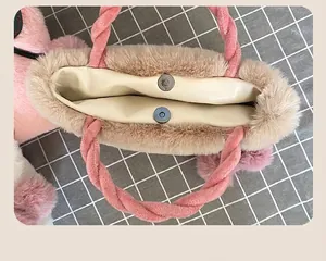 Close-up of plush faux rabbit fur handbag featuring a secure magnetic snap closure