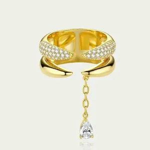 Detail of a gold-plated double-layer open ring with a pear-shaped zircon drop chain.