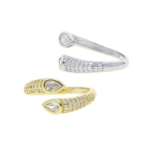Detailed view of elegant gold and silver bypass rings with pear-cut cubic zirconia stones