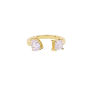 Detail shot of golden open ring featuring pear and square-cut cubic zirconia stones.