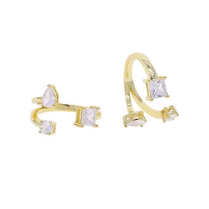 Detailed view of gold open ring with teardrop and square cubic zirconia stones