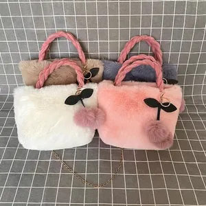 Faux rabbit fur handbag with a cute cherry charm and stylish braided pink handles