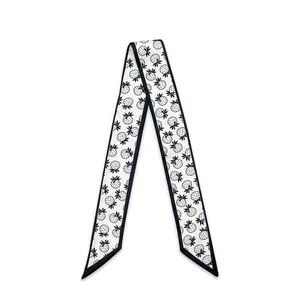 Detailed view of white skinny scarf with dark strawberry print and borders