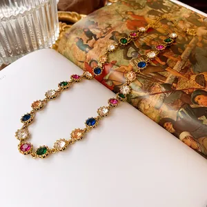 Detailed macro view of a vintage court style necklace with vibrant colorful rhinestones
