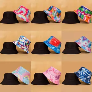 Collection of reversible tie-dye bucket hats with various colorful vibrant patterns.