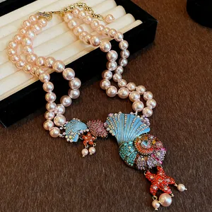 Close-up of vintage multi-strand pearl necklace with enamel seashell and starfish