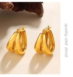 Elegant golden chunky C-shape hoop earrings featuring a modern geometric twisted design
