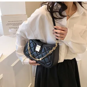 Elegant black quilted shoulder bag for women shown worn as a stylish armpit bag