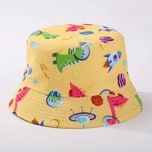 Detailed view of yellow children's bucket hat with dinosaur and space prints